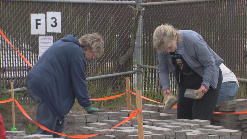 People search for their commemorative bricks from Anchorage's Town Square