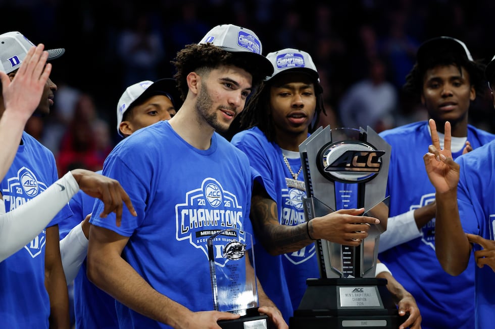 Duke forward Cameron Boozer, left, hold his Most Valuable Player Award as Duke celebrates...
