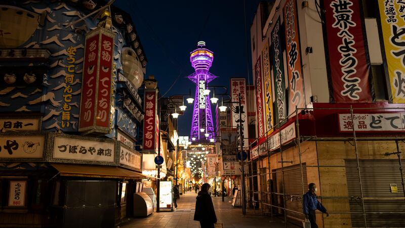 In this April 19, 2021, file photo, a restaurant staff member, center, stands in the middle of...