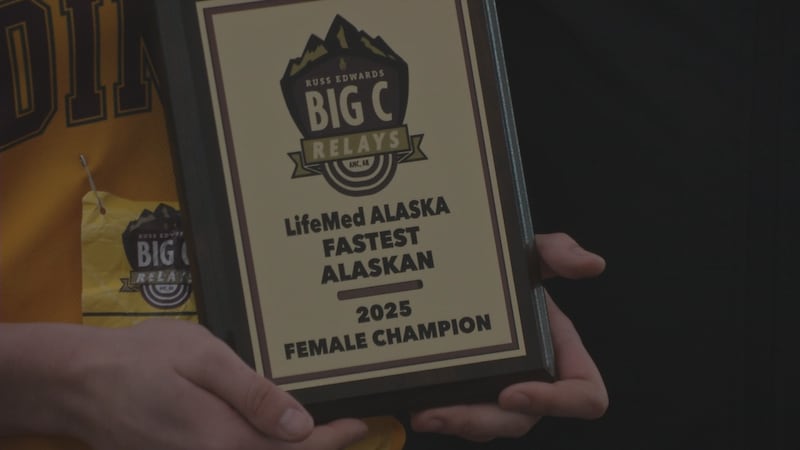 Dimond's Sarah Dittman holds up award after winning the 100m at the 2025 Big C Relays