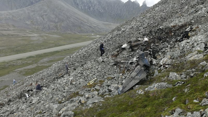 NTSB investigators on Sunday document the accident scene and wreckage field from the Aug. 20...