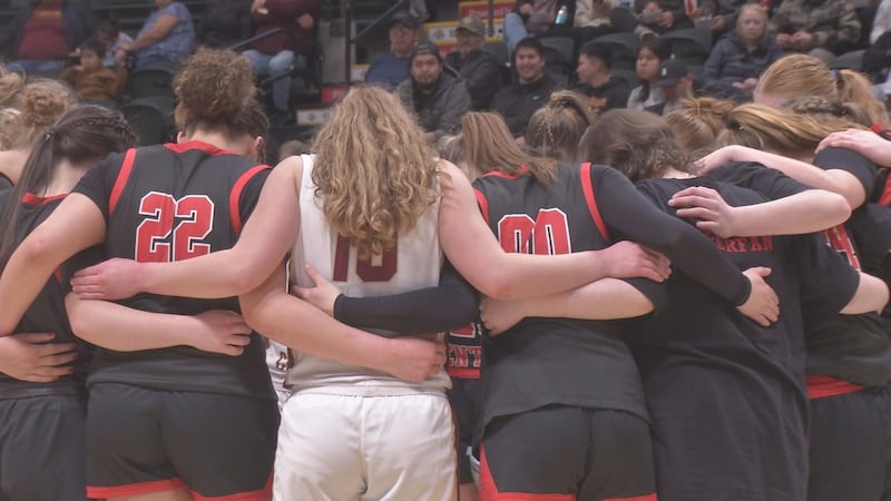 Grace Christian and Kenai players pray post-game after the Grizzlies defeated the Kardinals in...