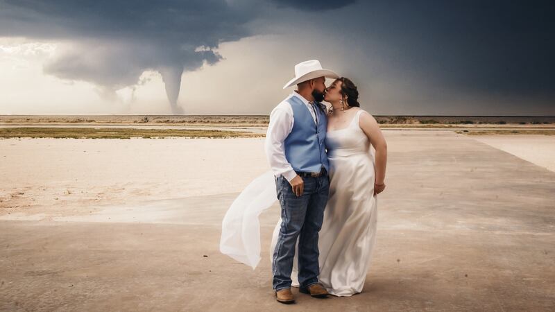 A Portales couple’s wedding photo is going viral, showing a massive tornado in the background....