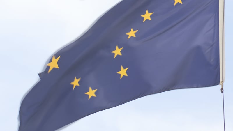 The Alaska state flag waves outside of the Anchorage Legislative Office Building in Spenard.