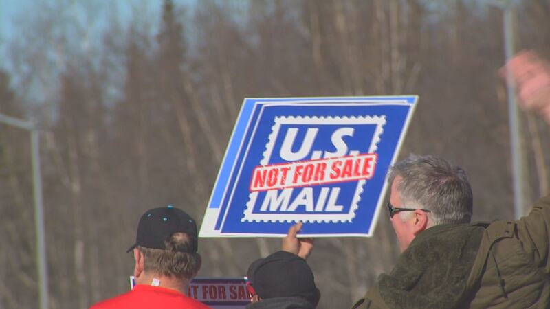 Residents and postal workers took to the corner of Northern Lights Blvd. and Seward Highway to...