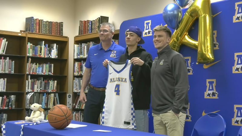 Monroe senior Jett McCullough (middle) stands with UAF head coach Frank Ostanik (left) and...