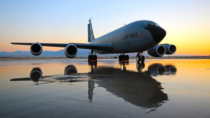 A Utah Air National Guard KC-135R Stratotanker casts its reflection on a watered down flight...