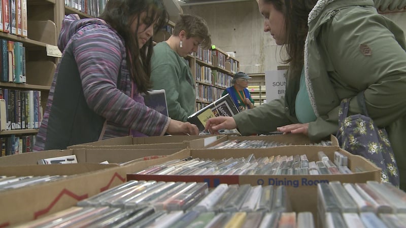 CDs and audiobooks filled the library's "dungeon," and browsers could take as many as they...