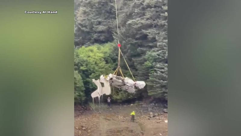 Newly obtained video shows crews using a helicopter to pull the wreckage of a small plane from...