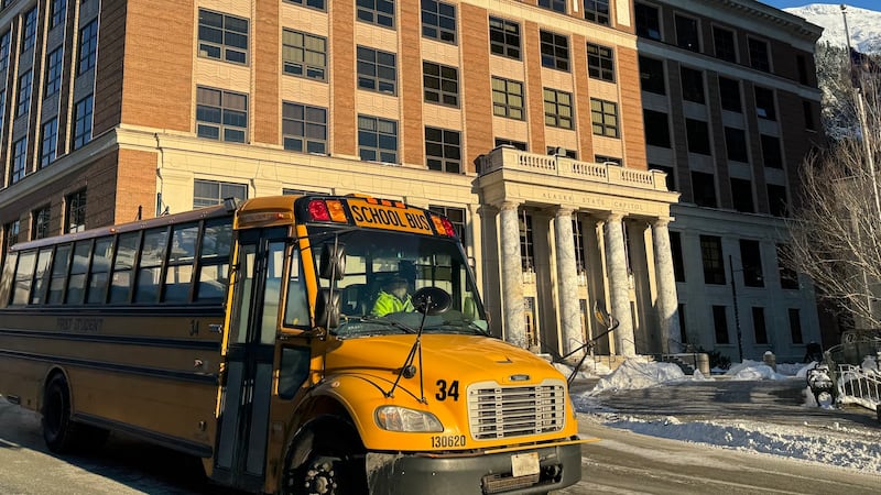 A school bus drives in front of the Alaska State Capitol on Monday, Feb. 3, 2025. (Photo by...