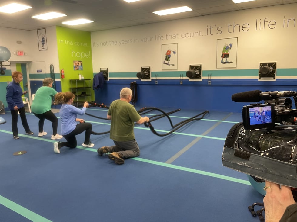 Members at BFit and Well using battle ropes during a morning class.
