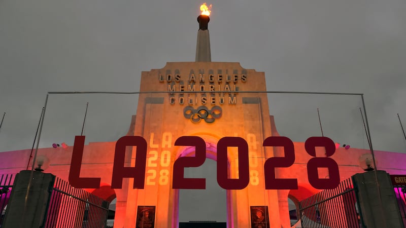 FILE - An LA 2028 sign is seen in front of the Olympic cauldron at the Los Angeles Memorial...
