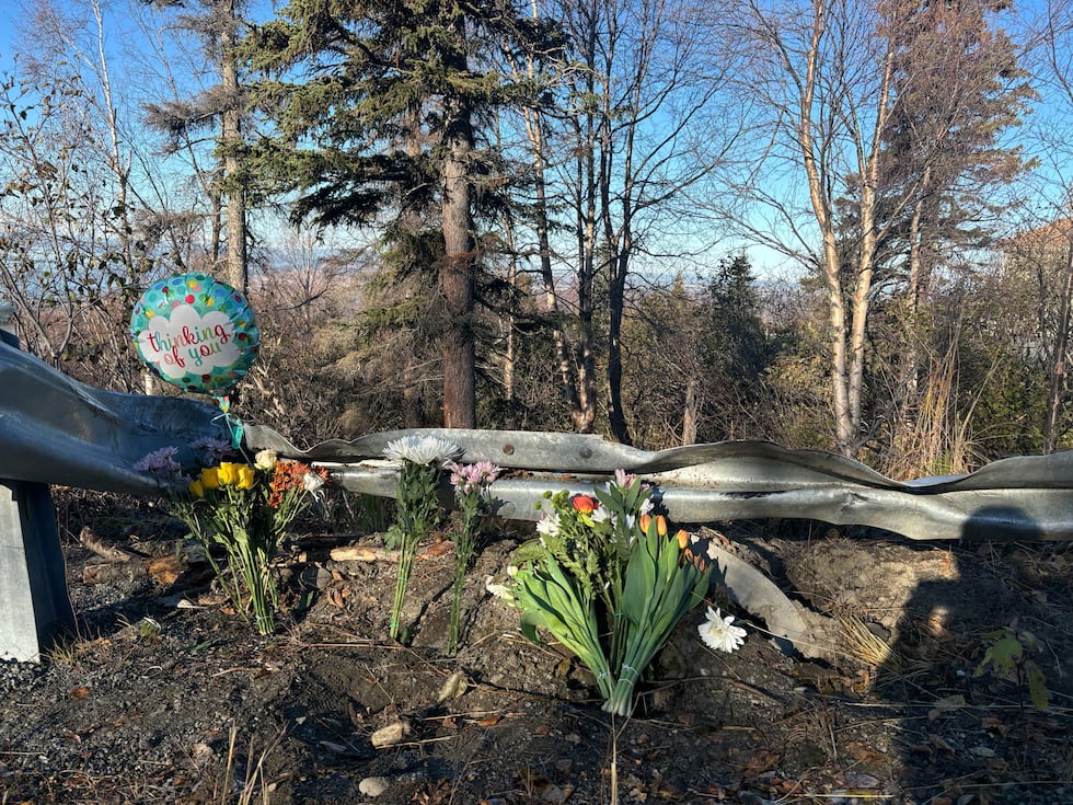 A memorial with flowers and balloons has been left at the site of a deadly crash that left an...
