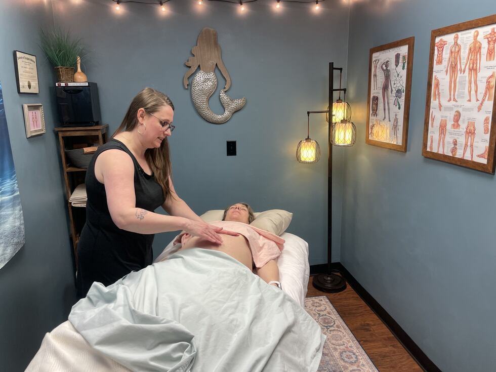 Jamie Newsom Eaton is performing lymphatic drainage on her pregnant client Lindsay Gerrod...