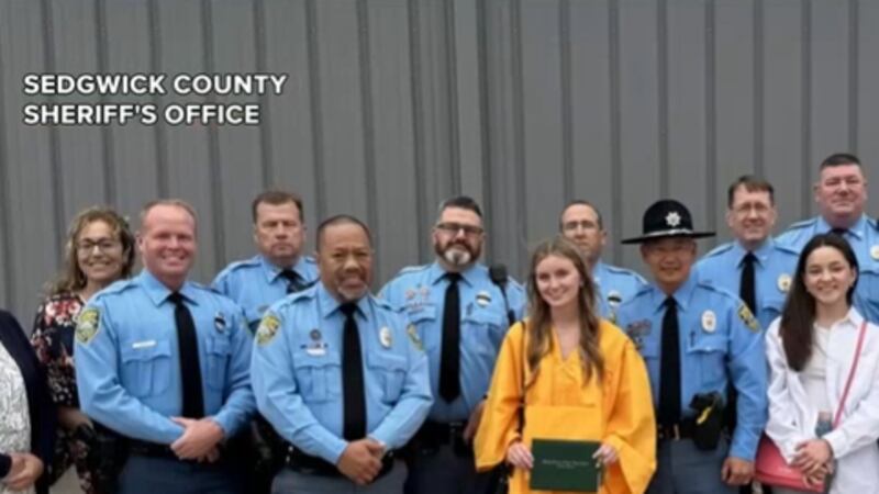 Members of the Sedgwick County Sheriff's Office celebrate the high school graduation of...