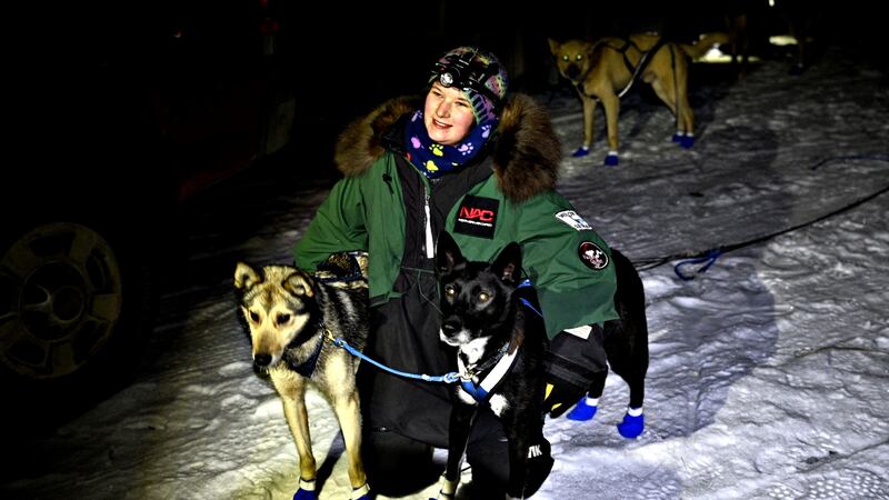 17-year old Emily Robinson, of Nenana, poses with her lead dogs after winning the Knik 200...