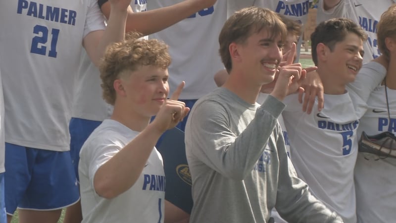 Cole Miller (Left) Posses for a picture with the Palmer Moose Soccer Team after winning the...