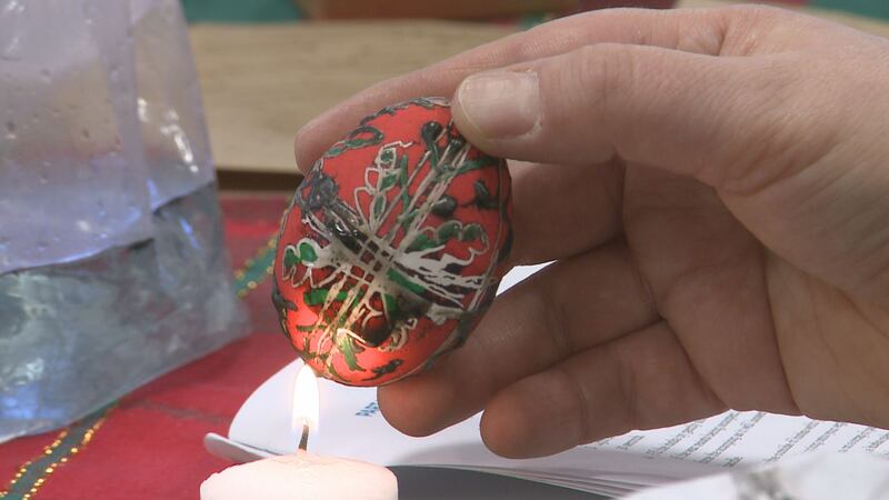 Melting away the beeswax layer on the hollowed egg reveals intricately-dyed pattern.