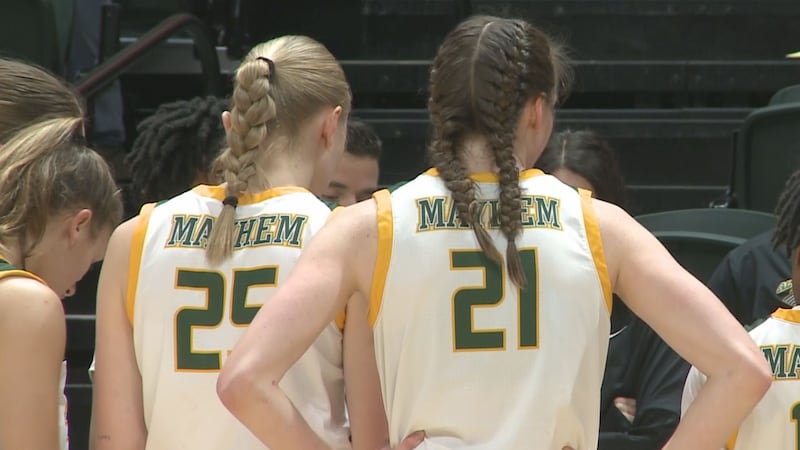 Hedda Koehne (left) and Tori Hollingshed (right) listen in the huddle during the Seawolves...
