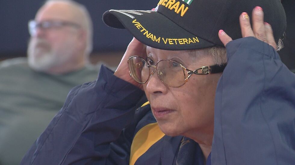 Veteran Josephine Huskey adjusts her hat as she prepares to board the Last Frontier Honor Flight