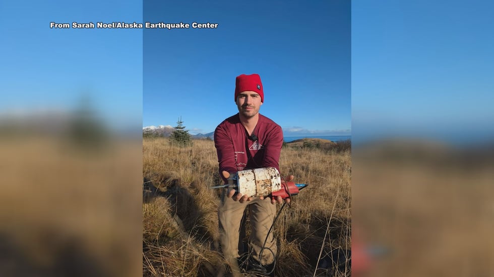 Cade Quigley holding one of the seismometers used for the project