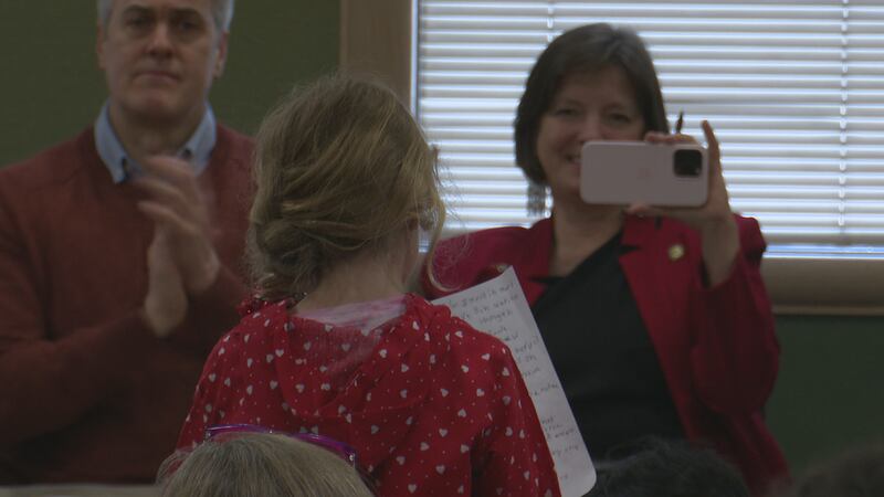 Rep. Andrew Gray (D-Anchorage) (left) and Rep. Carolyn Hall (D-Anchorage) (right) look on as a...