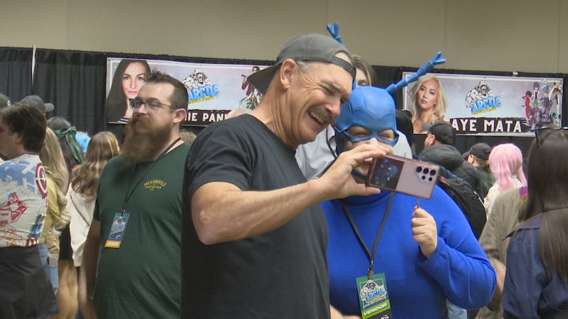 Actor Patrick Warburton takes a photo with a fan