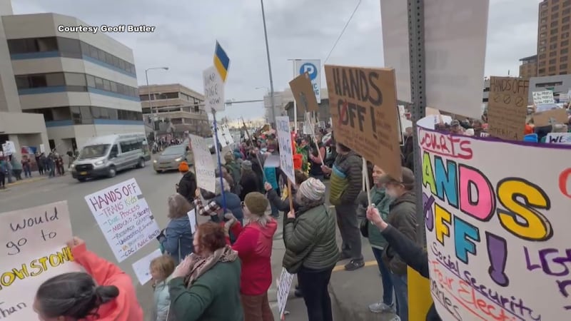 Alaskans held signs addressing numerous fears stemming from executive orders.