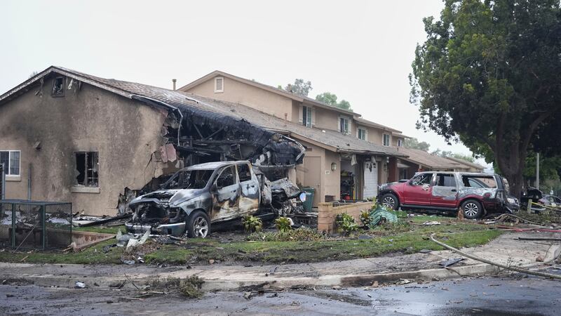 Vehicles and houses are damages after a small plane crashed into a San Diego neighborhood,...