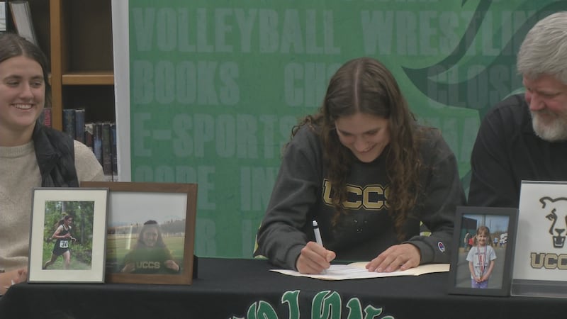 Colony Knight Ella Hopkins signs with the University of Colorado Springs in front of friends...