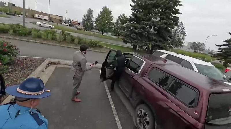 Man charged with murder after shooting at people rummaging through his car, police say